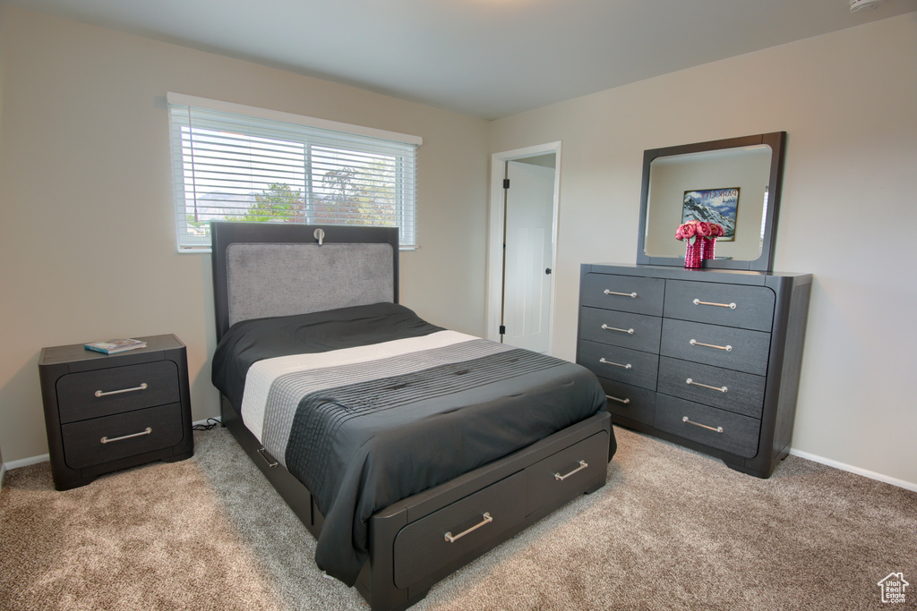 Bedroom featuring baseboards and light carpet