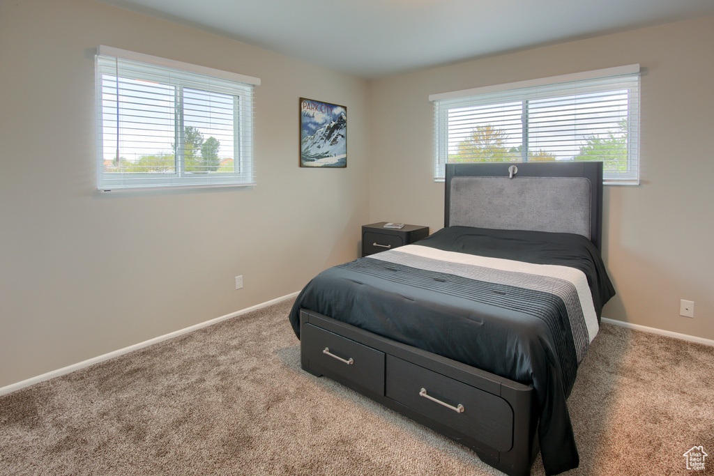 Bedroom featuring baseboards and carpet