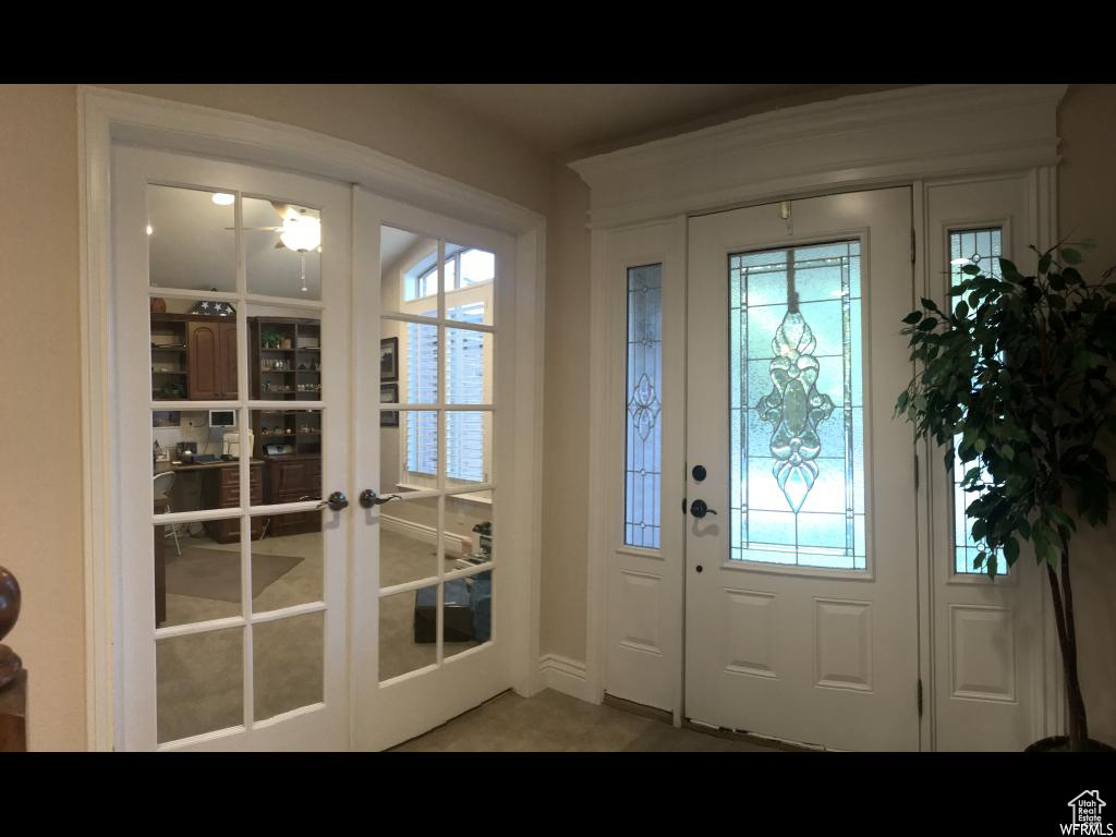 Doorway with baseboards and french doors