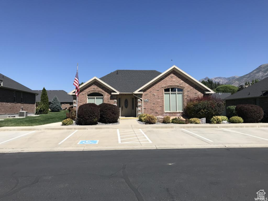 Ranch-style house with brick siding, uncovered parking, and central AC