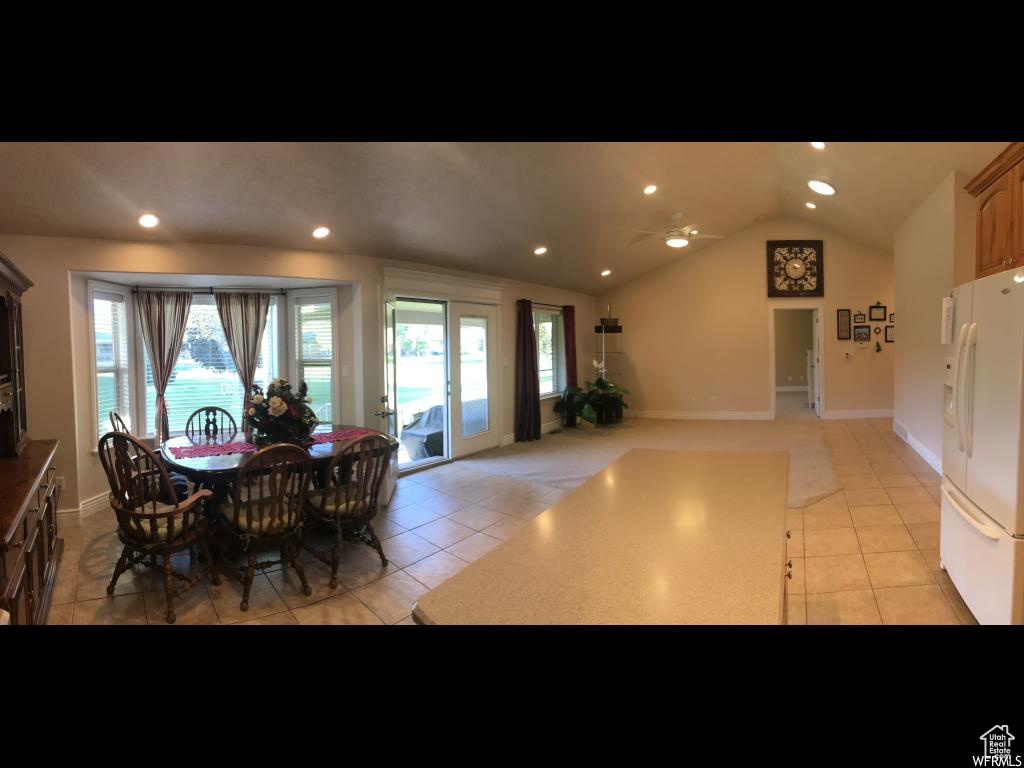 Dining room featuring recessed lighting, lofted ceiling, light tile patterned floors, and a wealth of natural light