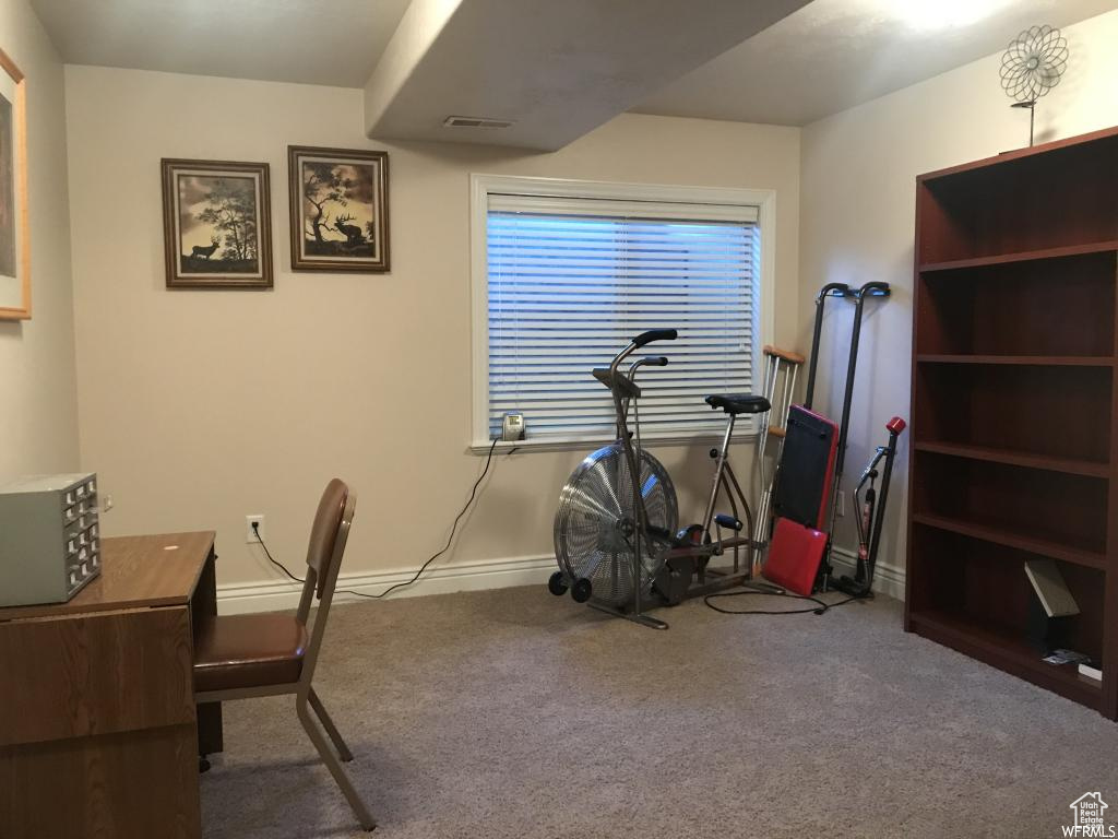Carpeted home office with baseboards and visible vents