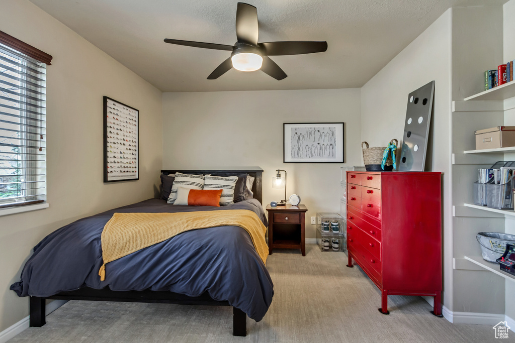 Carpeted bedroom with baseboards and ceiling fan