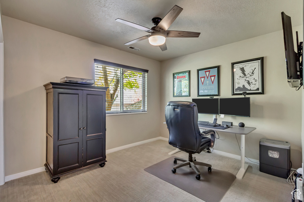 Office with a ceiling fan, visible vents, a textured ceiling, and baseboards