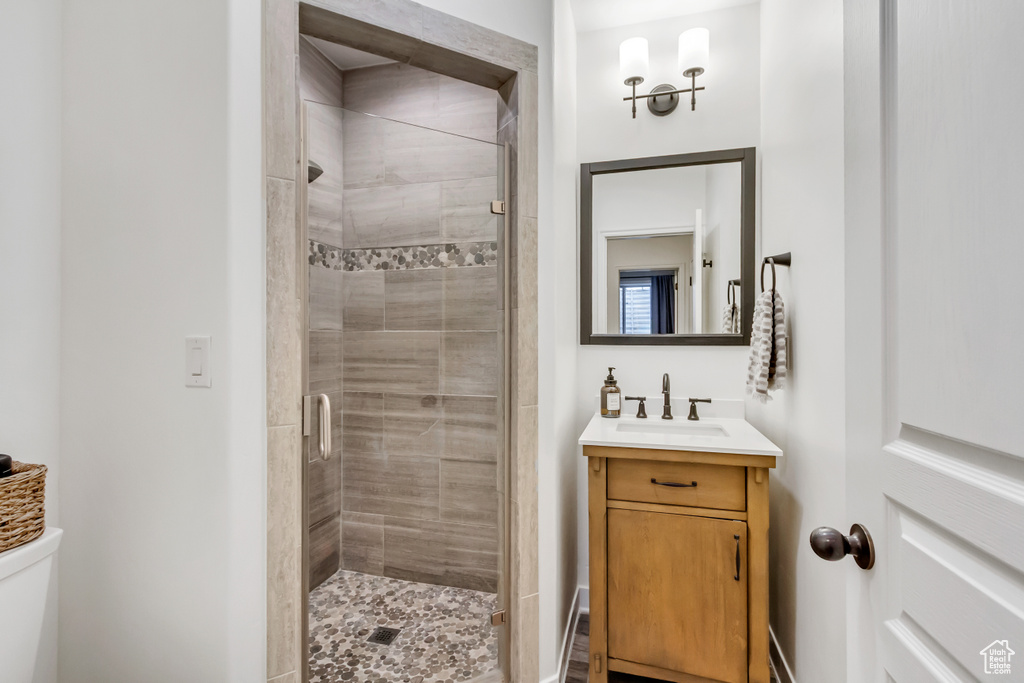 Bathroom featuring vanity and a stall shower