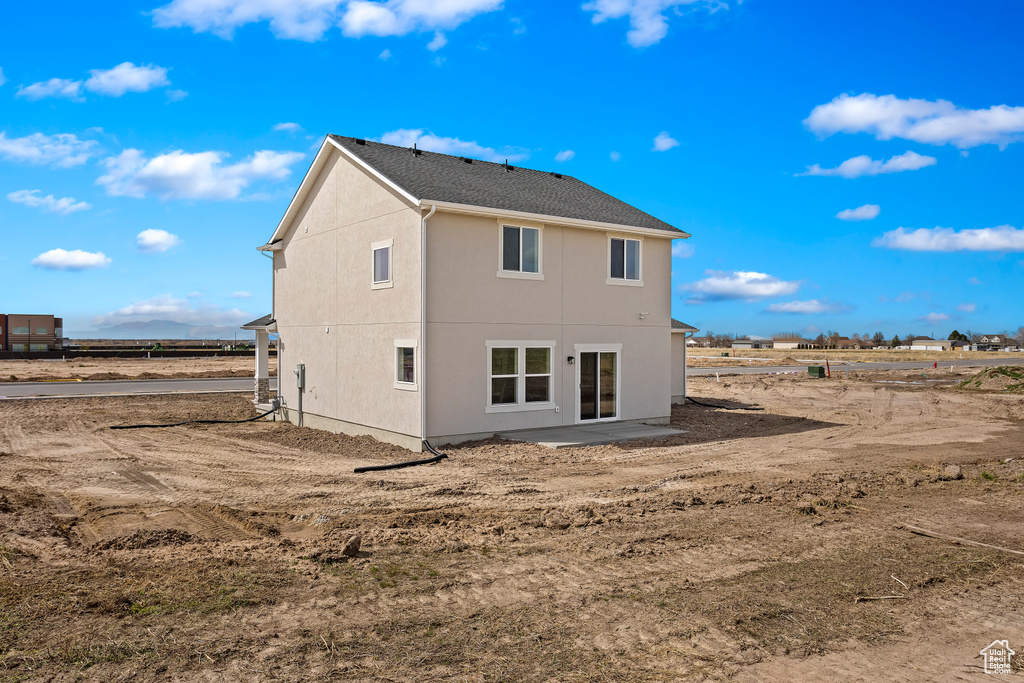 Rear view of property featuring stucco siding
