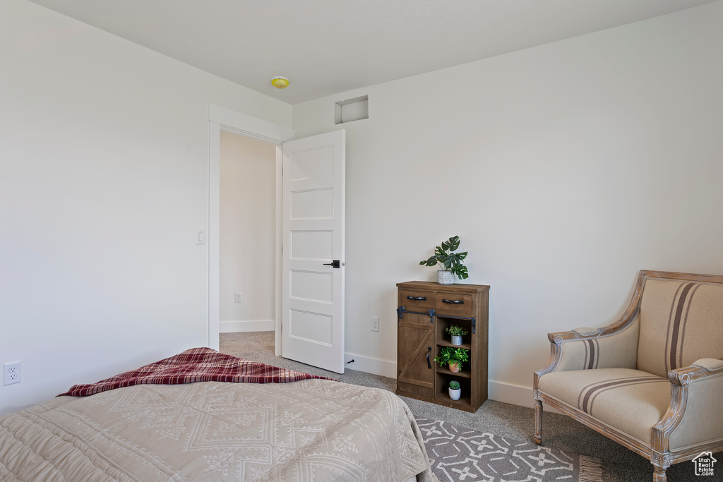 Bedroom featuring carpet floors and baseboards