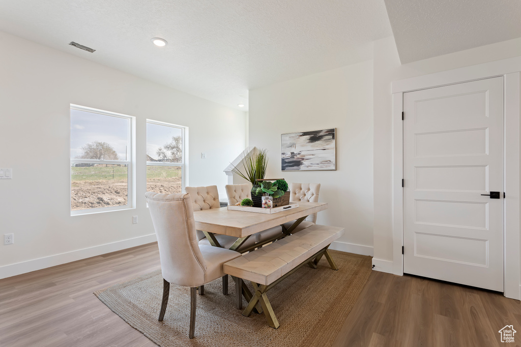 Dining room with recessed lighting, baseboards, and light wood finished floors