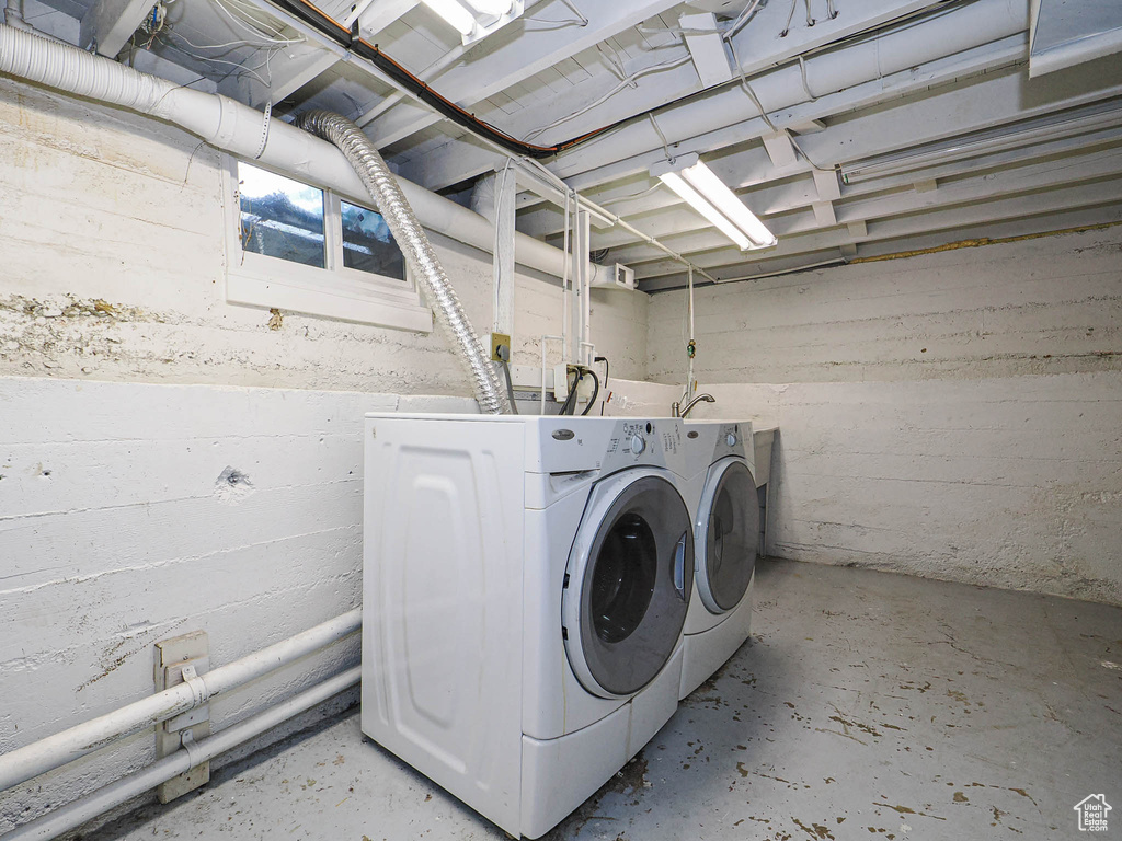 Clothes washing area featuring separate washer and dryer and laundry area
