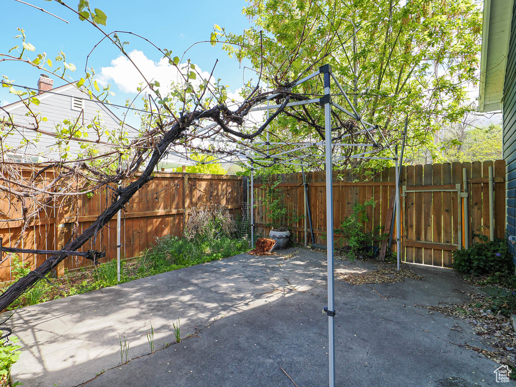 View of patio featuring fence