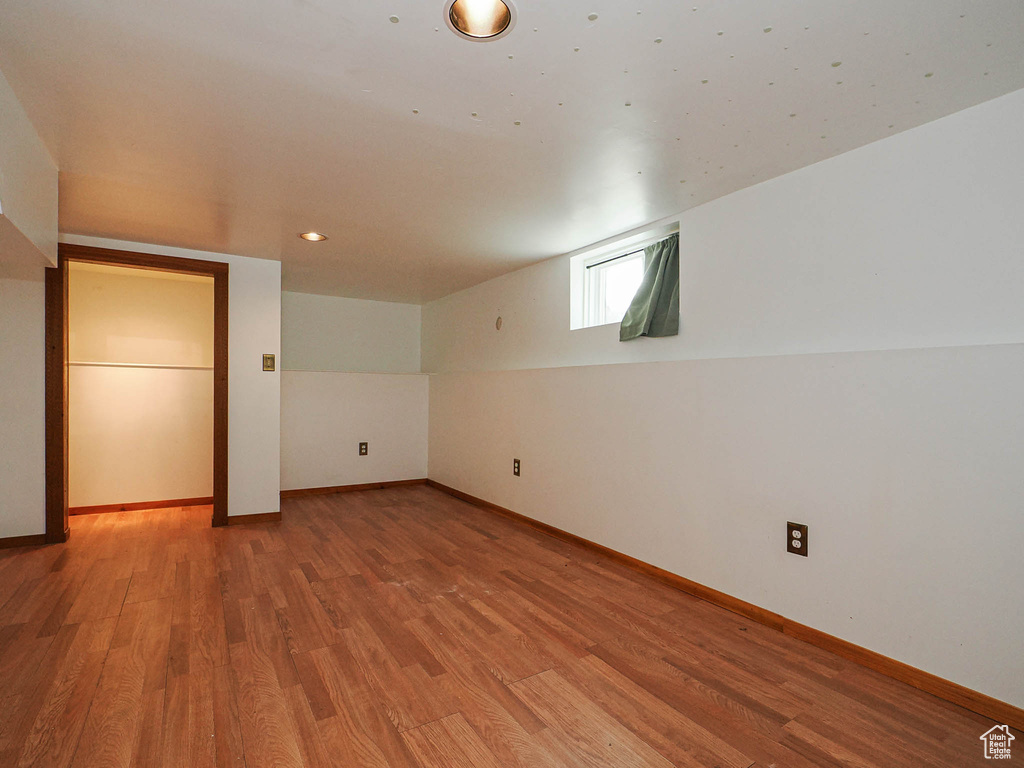 Below grade area featuring light wood-style floors and baseboards