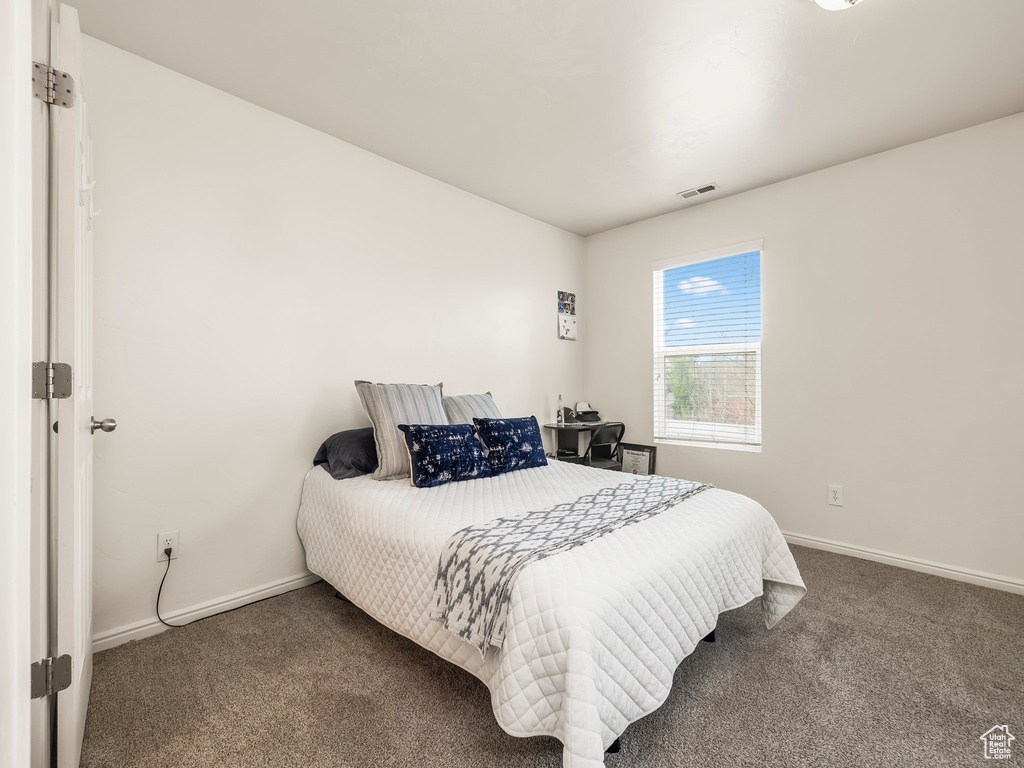 Bedroom featuring baseboards, carpet, and visible vents