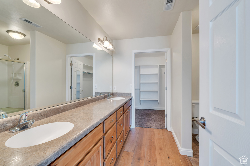 Full bathroom featuring visible vents, a sink, and a stall shower