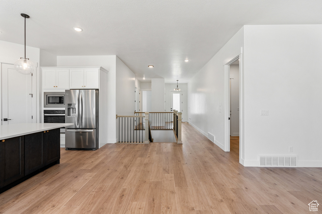 Kitchen featuring visible vents, light wood-type flooring, light countertops, and stainless steel appliances