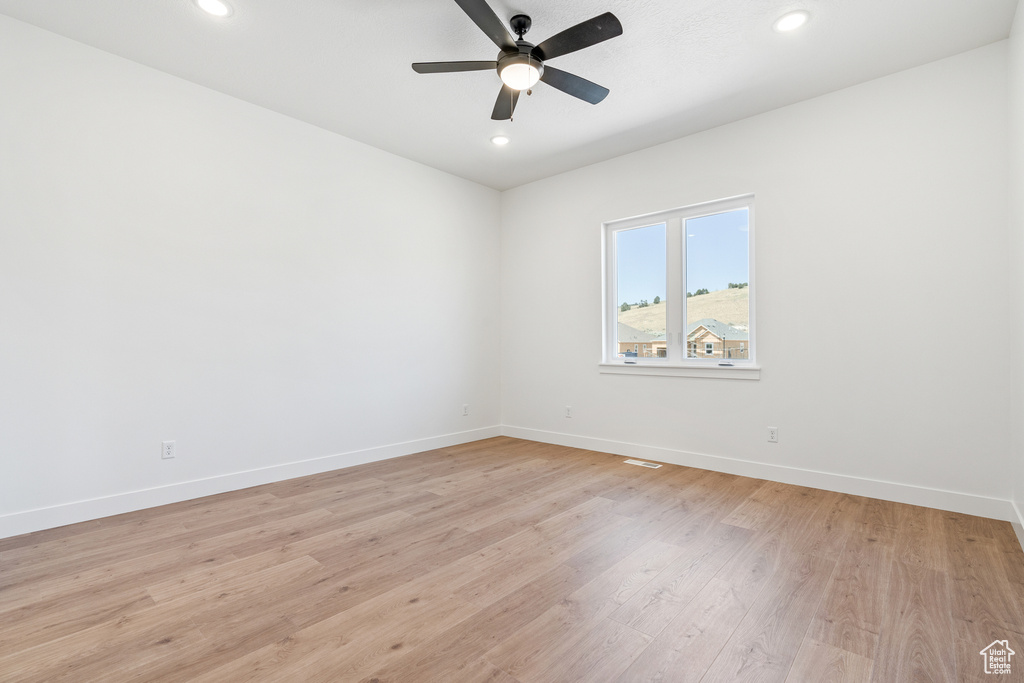 Empty room featuring recessed lighting, baseboards, ceiling fan, and light wood finished floors