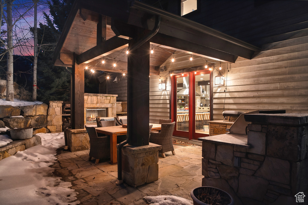 View of patio featuring an outdoor stone fireplace