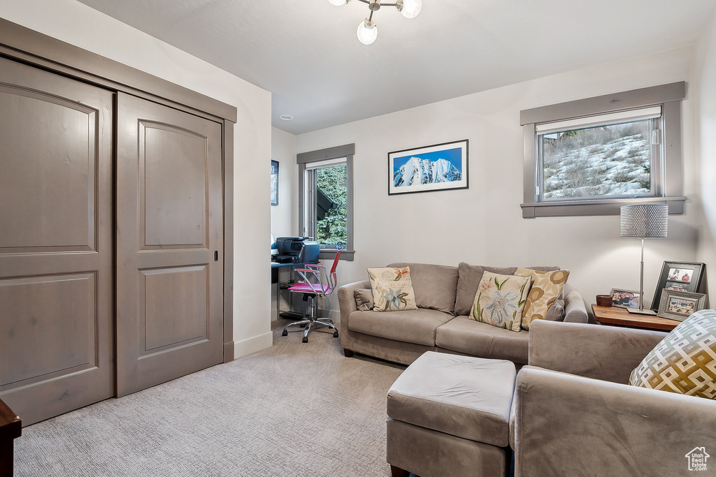 Carpeted living area with baseboards