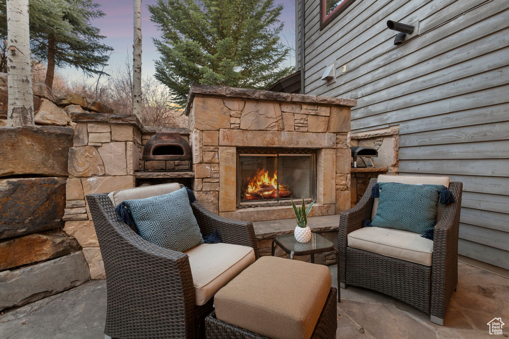 View of patio featuring an outdoor stone fireplace