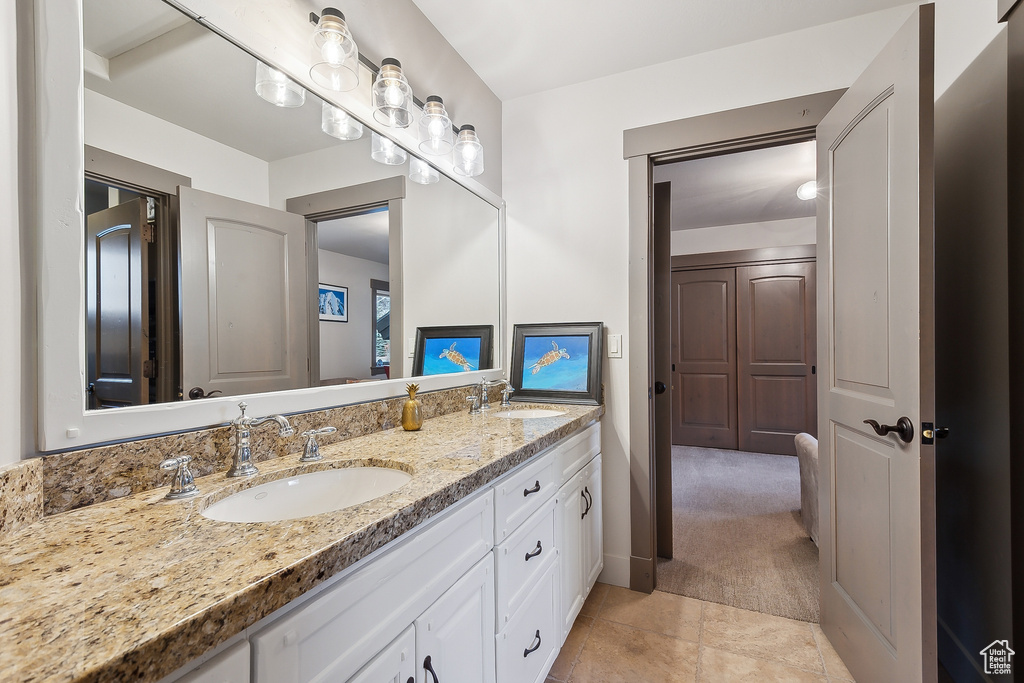 Full bathroom with a sink, tile patterned flooring, and double vanity