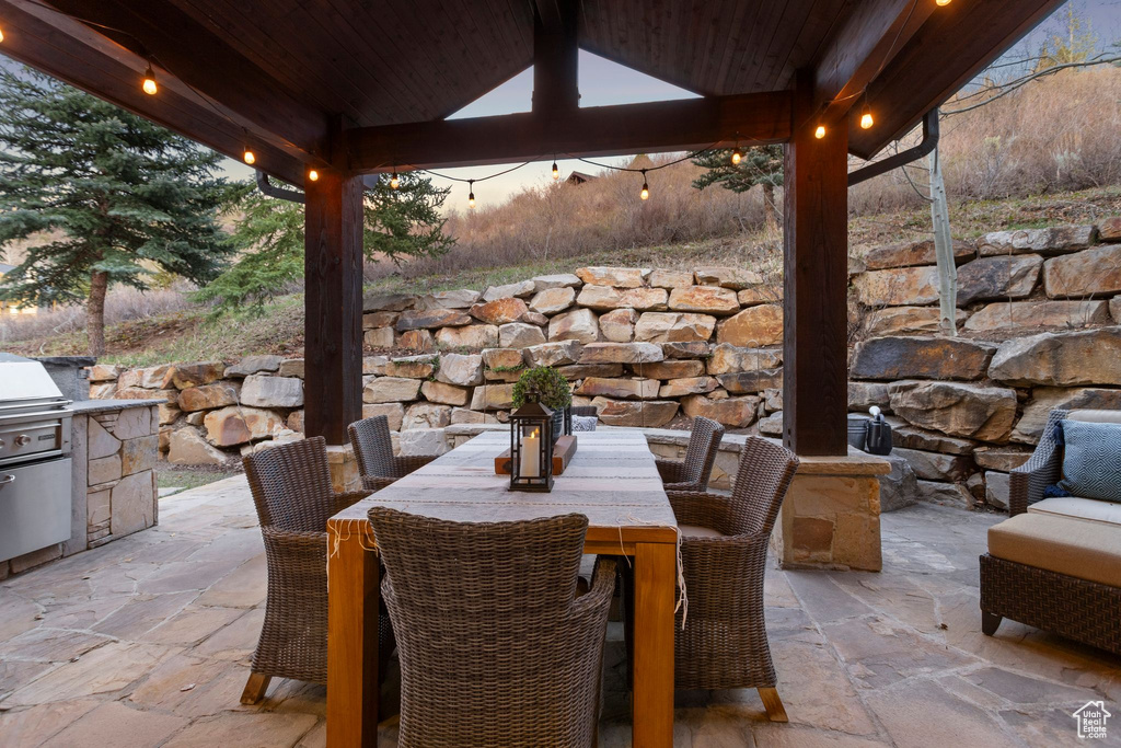 View of patio featuring a gazebo, outdoor dining area, and a grill