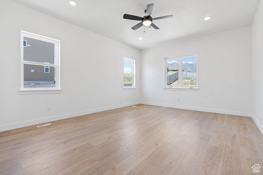 Unfurnished room with light wood-type flooring, recessed lighting, baseboards, and ceiling fan
