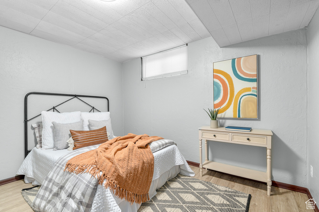 Bedroom with baseboards and wood finished floors