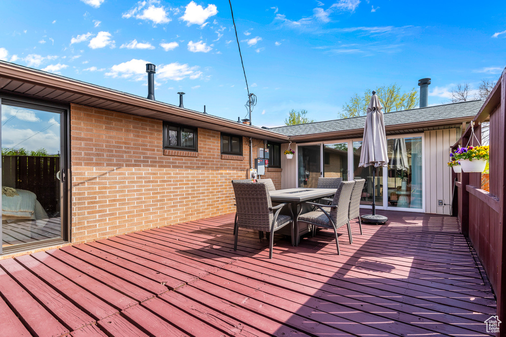 Wooden deck featuring outdoor dining area
