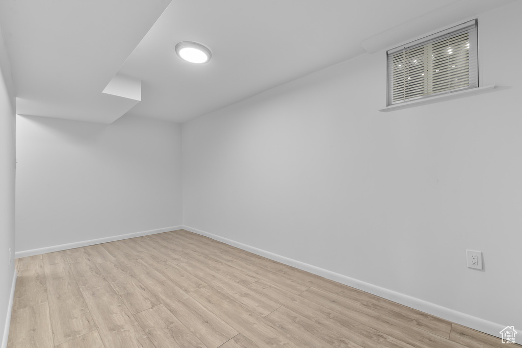 Empty room featuring baseboards and wood finished floors