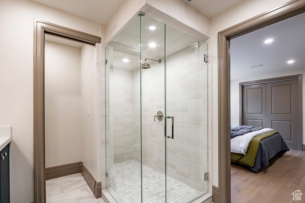Bathroom with vanity, recessed lighting, baseboards, and a stall shower