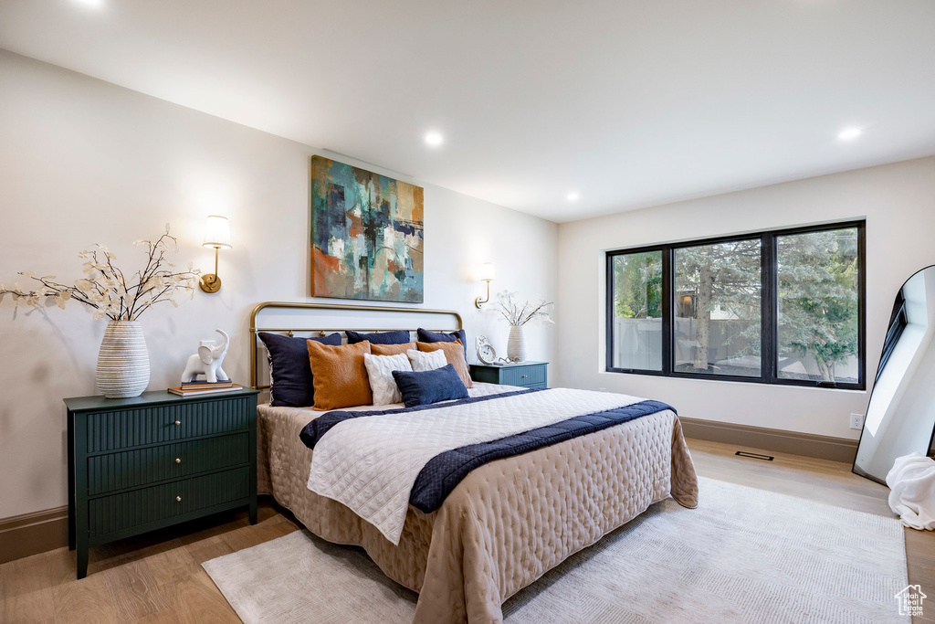 Bedroom featuring recessed lighting, baseboards, wood finished floors, and visible vents