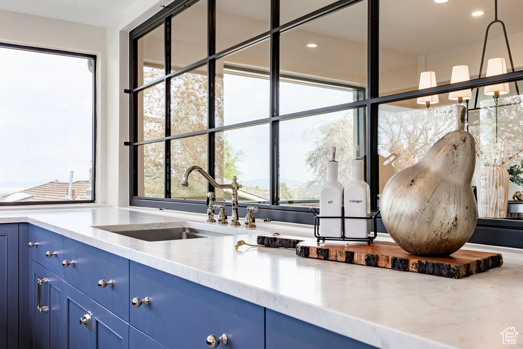Kitchen with a sink, recessed lighting, plenty of natural light, and blue cabinets