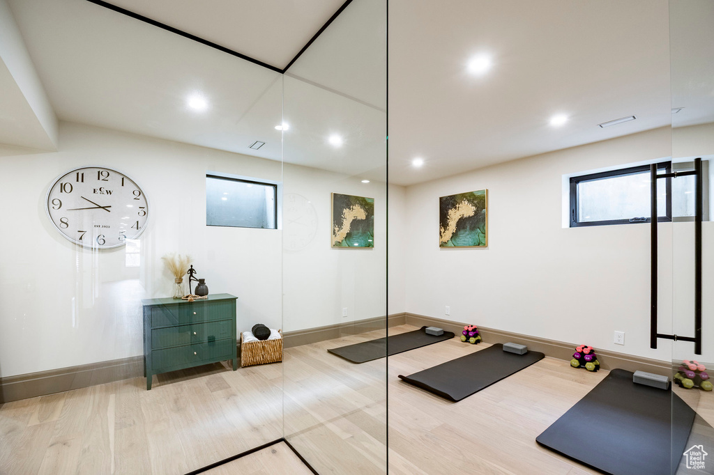 Exercise area featuring baseboards, recessed lighting, and wood finished floors