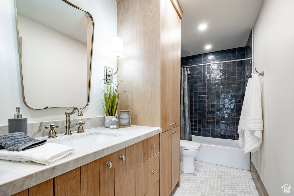 Full bathroom with toilet, shower / bathtub combination with curtain, tile patterned flooring, and vanity