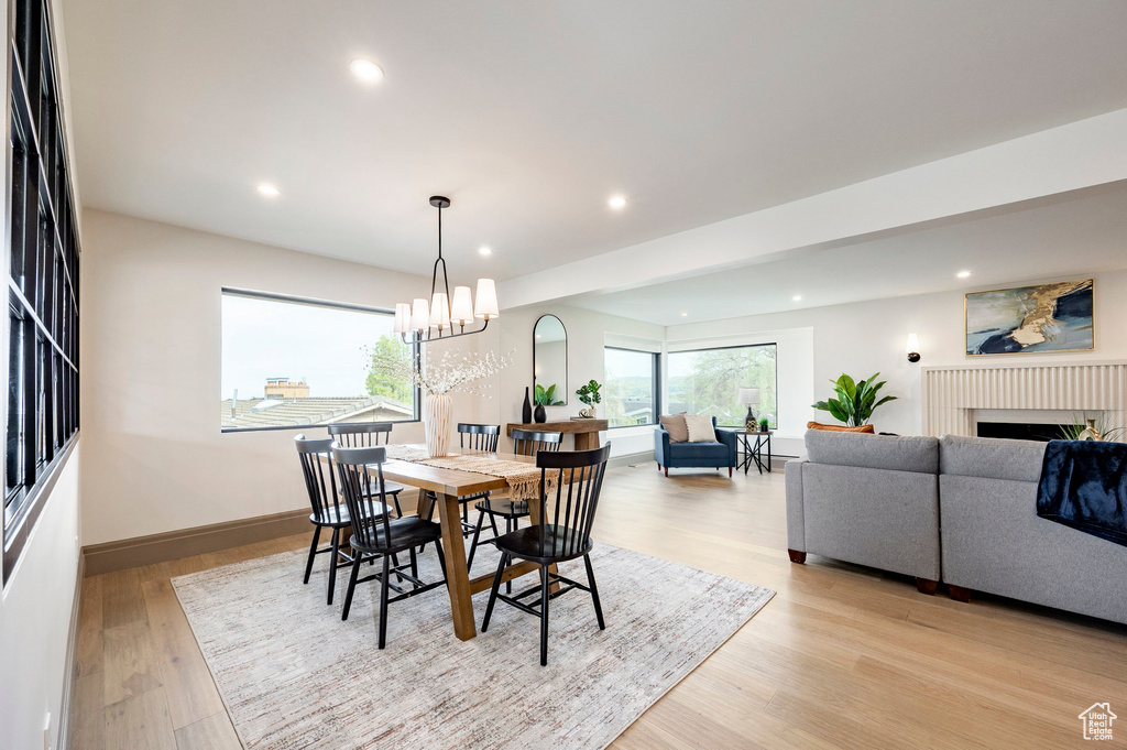 Dining space featuring recessed lighting, light wood finished floors, baseboards, and a fireplace