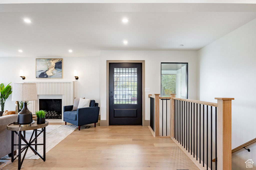 Foyer entrance featuring light wood-type flooring, recessed lighting, and a fireplace