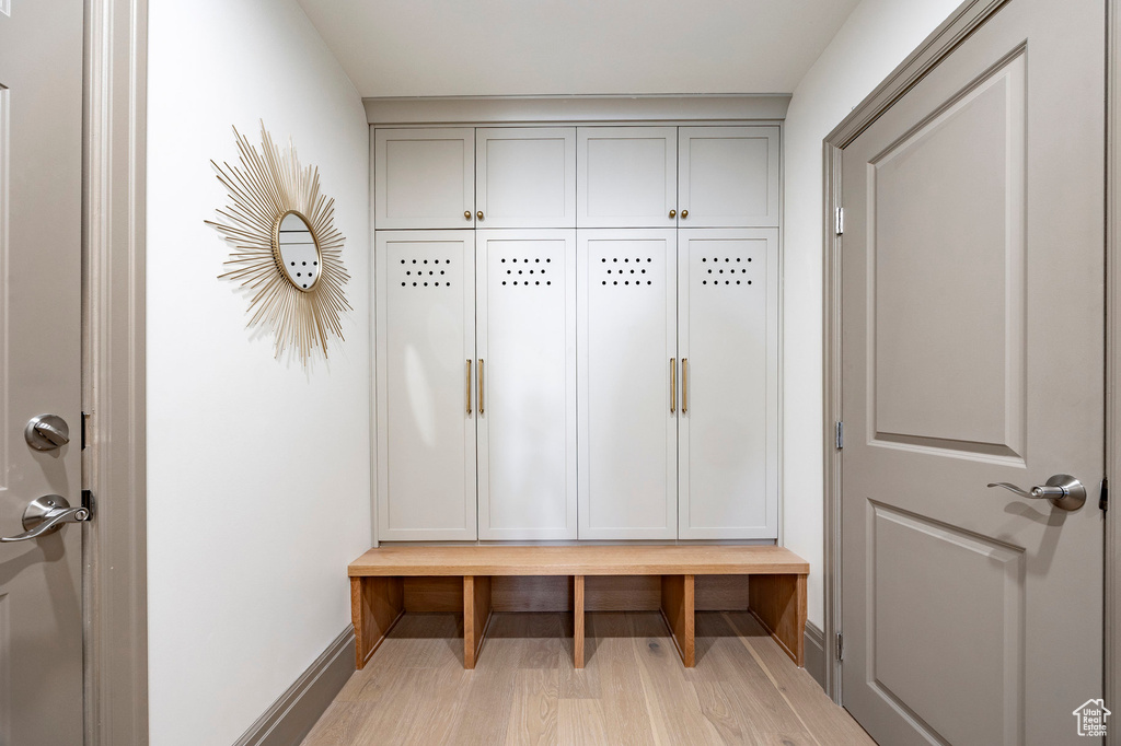 Mudroom with baseboards and wood finished floors
