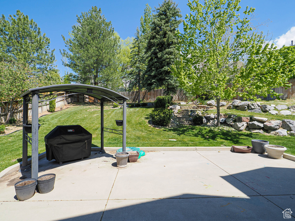 View of patio featuring a gazebo and fence