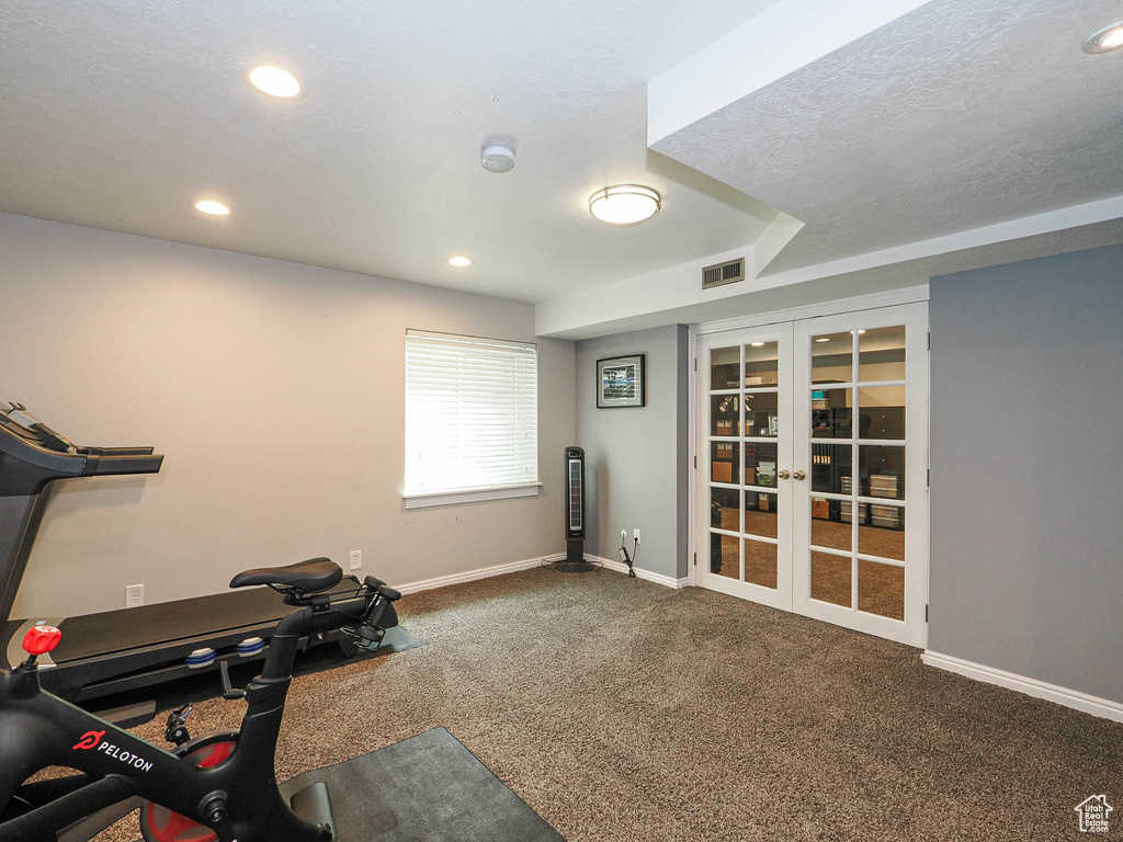 Exercise room featuring carpet flooring, french doors, recessed lighting, baseboards, and visible vents