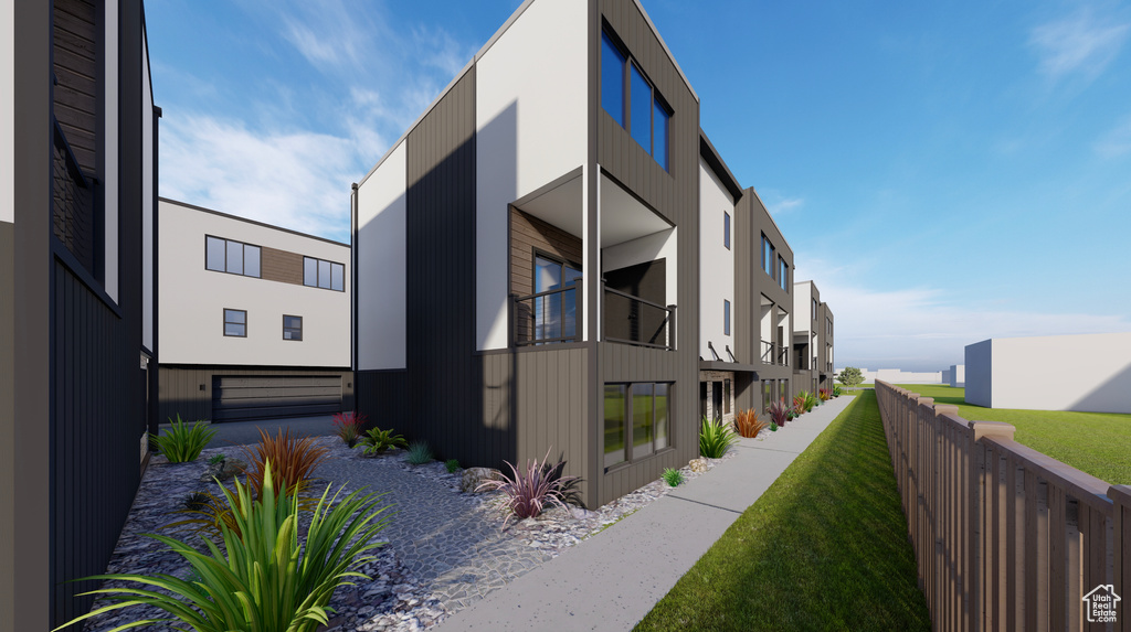 View of home\\\'s exterior with a yard, fence, and driveway