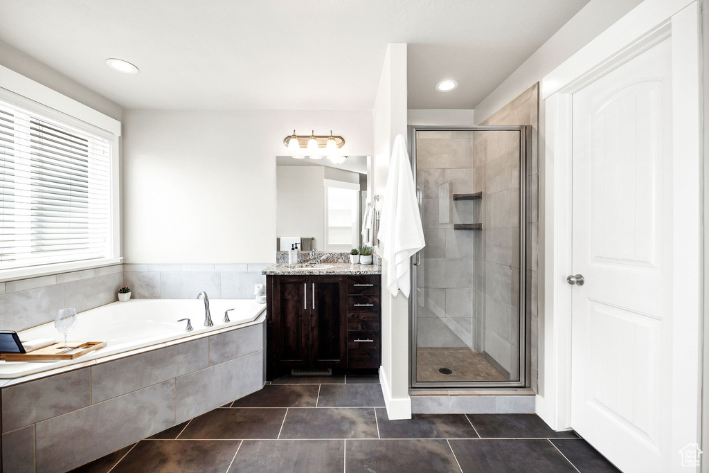 Bathroom featuring tile patterned flooring, a garden tub, vanity, recessed lighting, and a stall shower