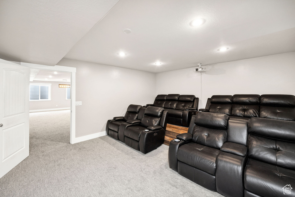 Carpeted home theater with recessed lighting and baseboards