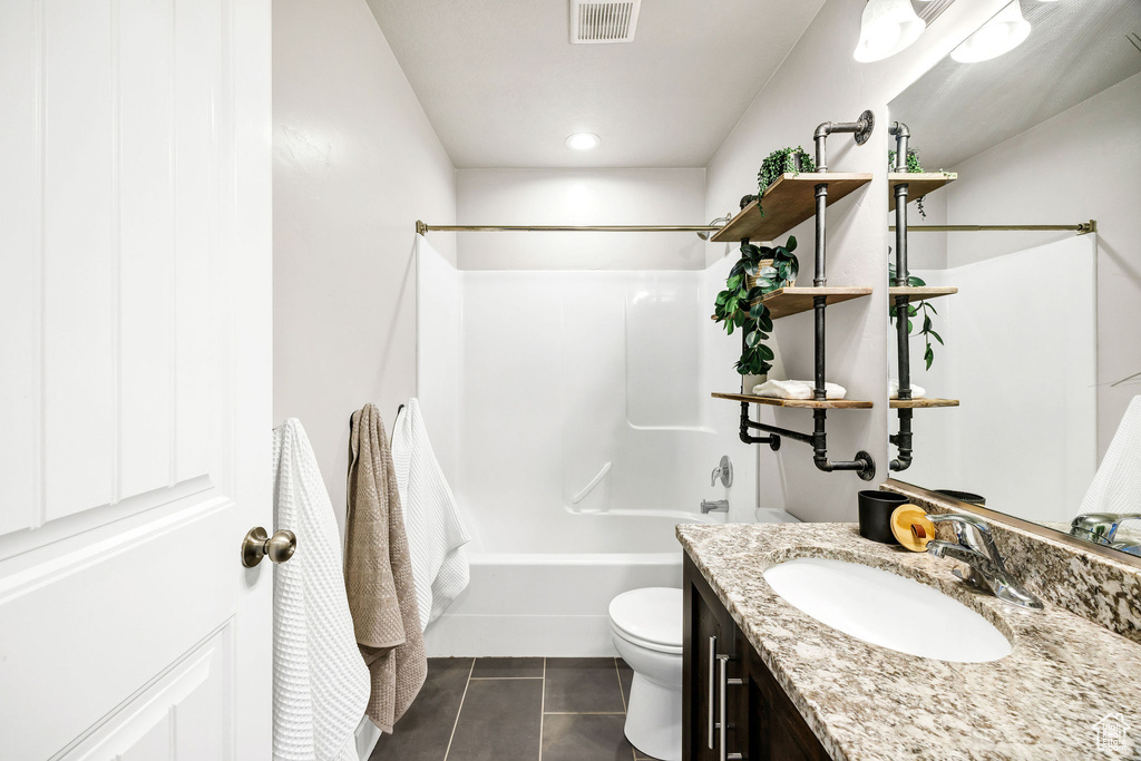 Full bathroom with tile patterned flooring, vanity, toilet, shower / bath combination, and visible vents