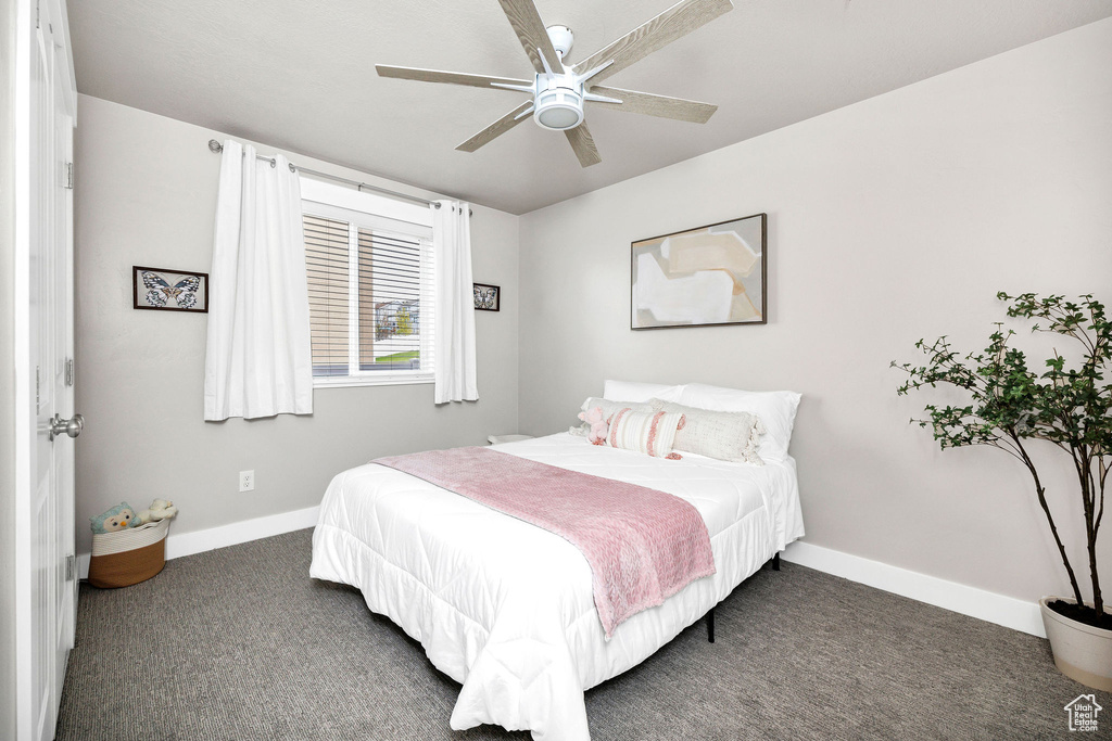 Bedroom featuring baseboards, a ceiling fan, and carpet floors