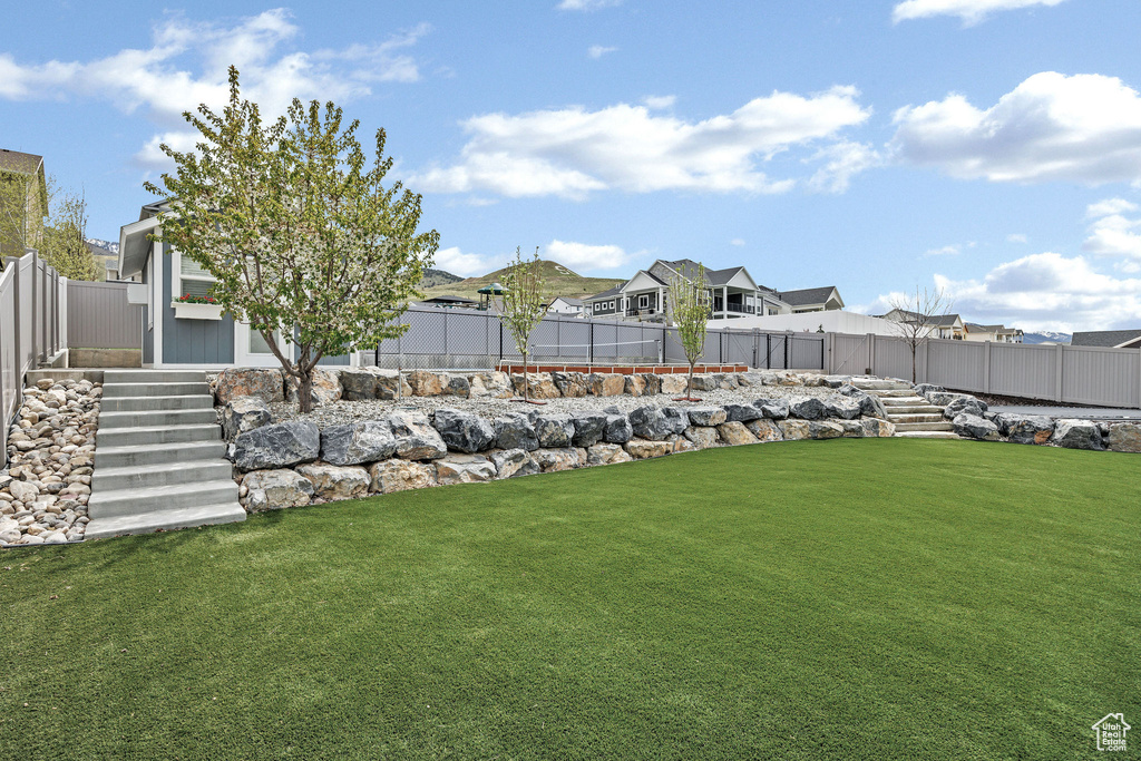 View of yard featuring a fenced backyard and a residential view
