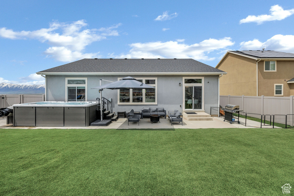 Back of house featuring a yard, a fenced backyard, an outdoor hangout area, and a patio area