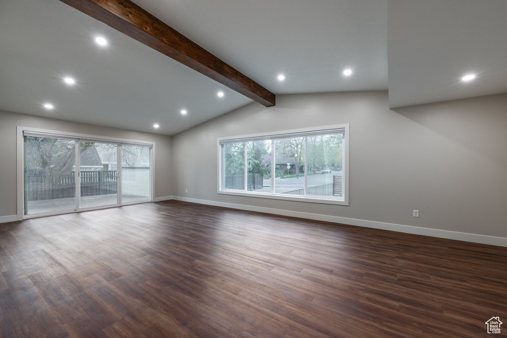 Unfurnished living room with recessed lighting, baseboards, vaulted ceiling with beams, and dark wood-type flooring