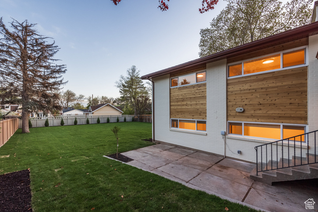 View of yard featuring a fenced backyard and a patio area