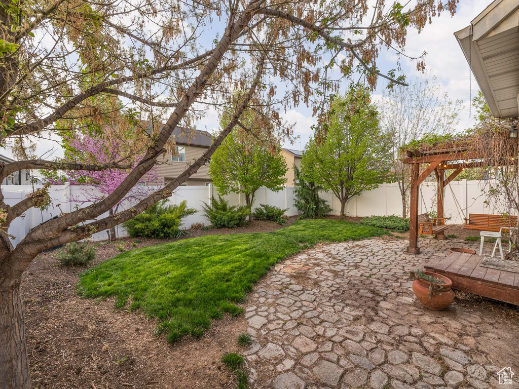View of yard with a pergola, a patio area, and a fenced backyard