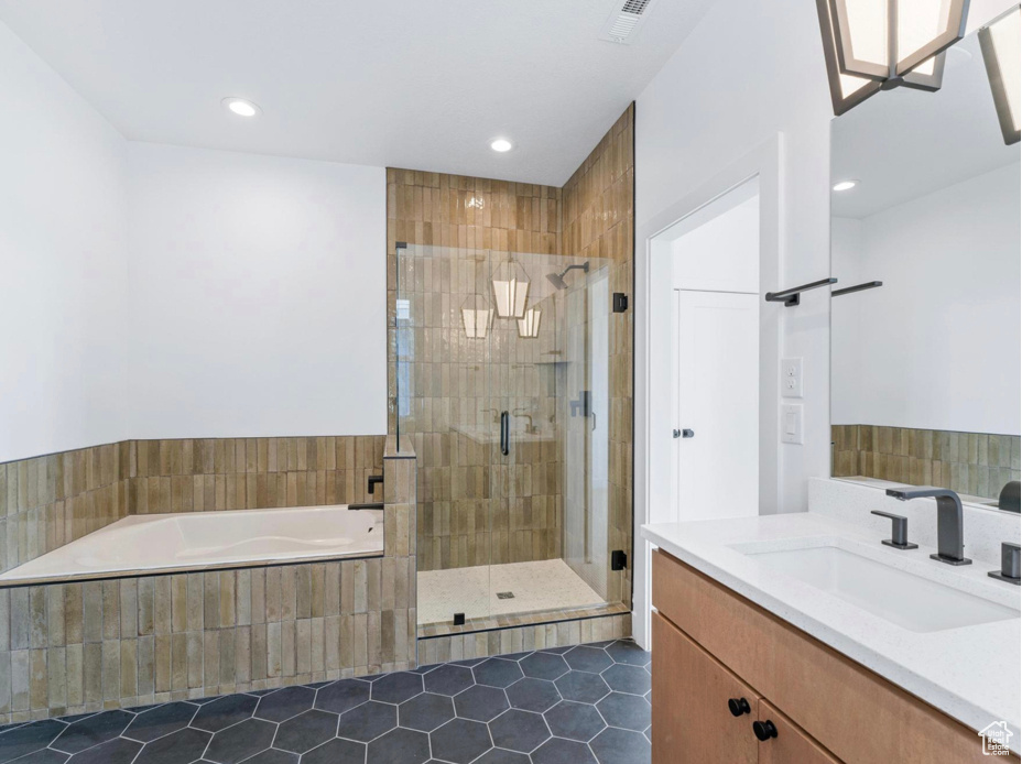 Bathroom with tile patterned flooring, recessed lighting, a shower stall, visible vents, and a bath