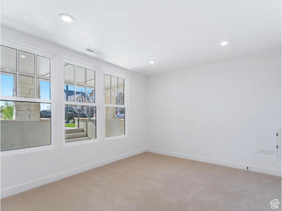 Spare room featuring carpet floors, recessed lighting, baseboards, and visible vents